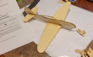 The completed P-40 ready for balancing with the provided
clay. I’ll admit the delicate parts representing the canopy
rails got the best of my fat fingers, but you could leave them in place for a more durable airframe.