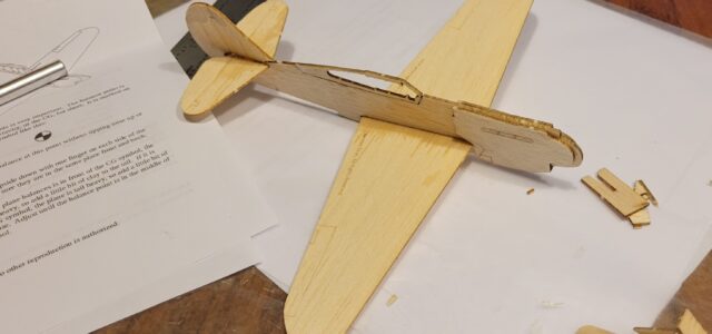 The completed P-40 ready for balancing with the provided
clay. I’ll admit the delicate parts representing the canopy
rails got the best of my fat fingers, but you could leave them in place for a more durable airframe.